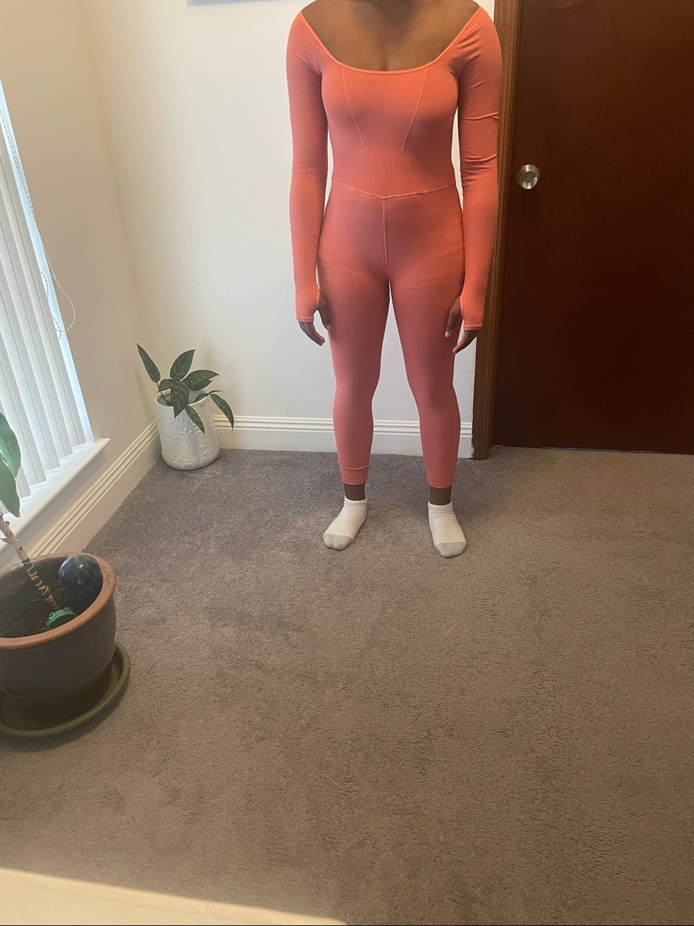 FP Movement by Free People Ribbed Open-Back Jumpsuit in Peachy color.